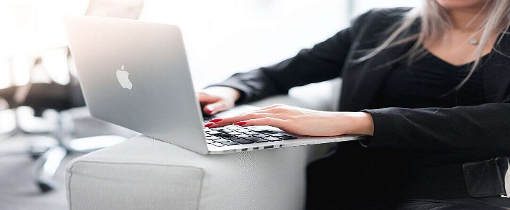 business-woman-using-her-laptop-on-a-sofa-free-photo-1080x720